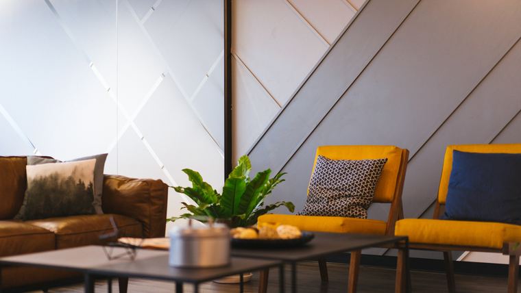 Office lounge area with a leather sofa, armchairs and a coffee table