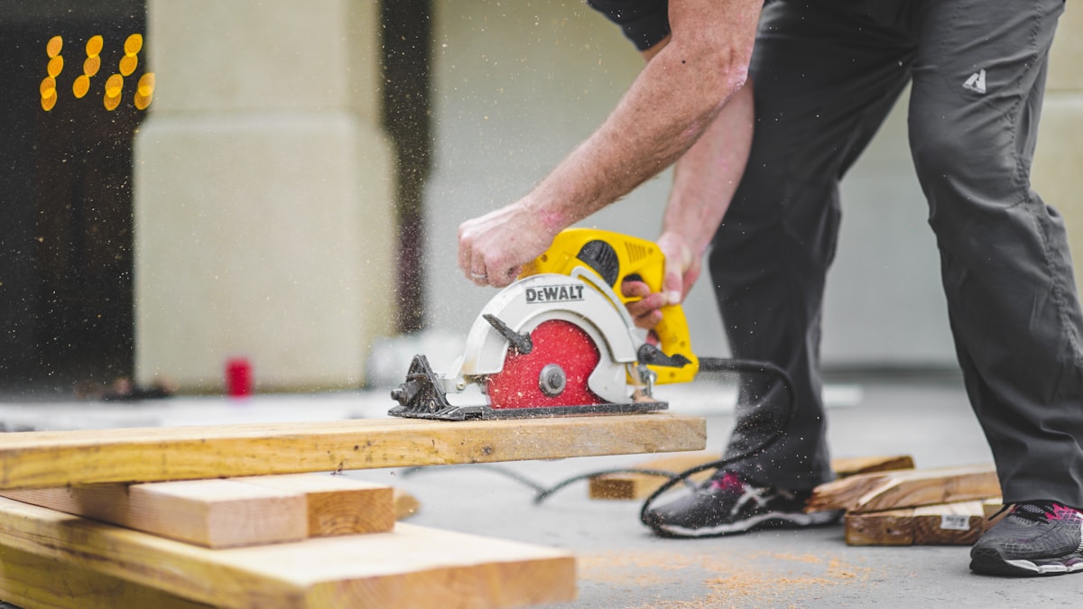 Auckland builder cutting timber on site