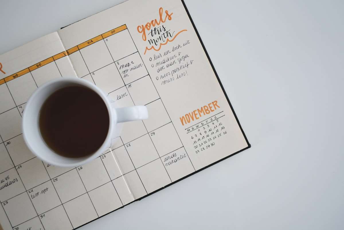 A calendar and a cup of coffee, planning a work session